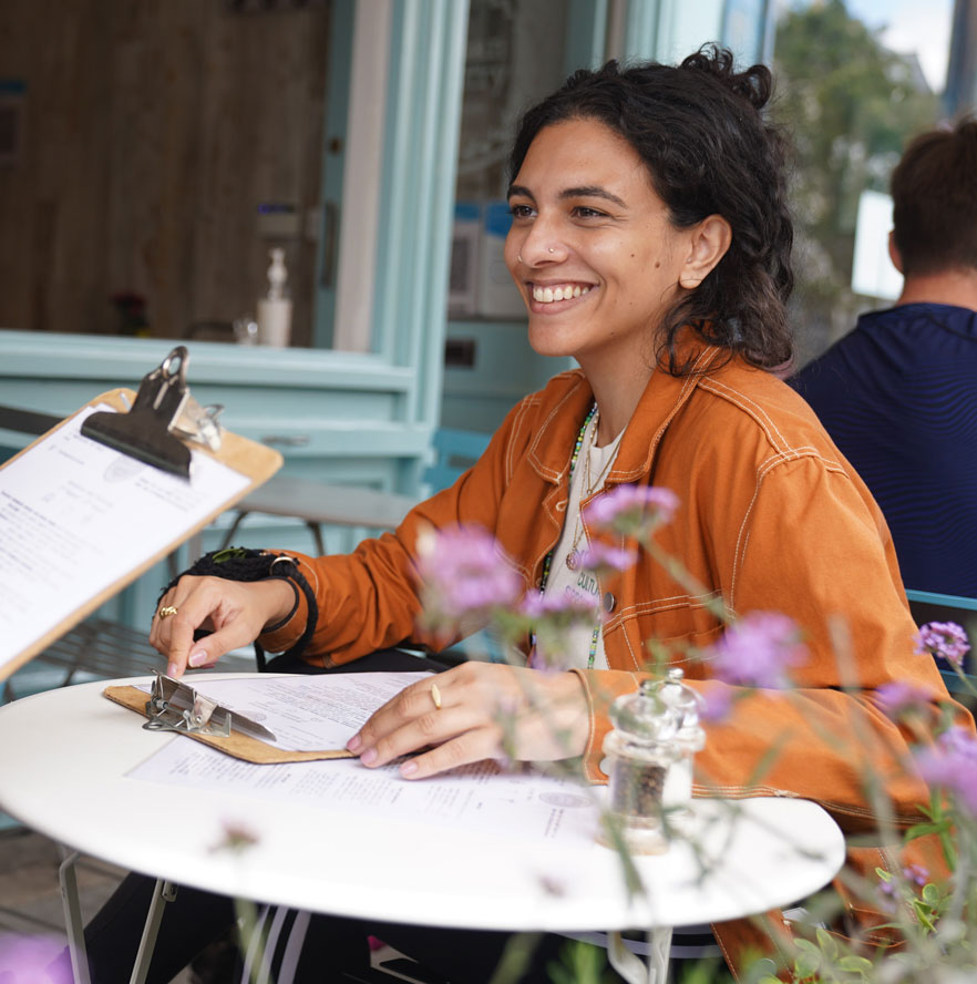 woman sits at cafe chiswick green